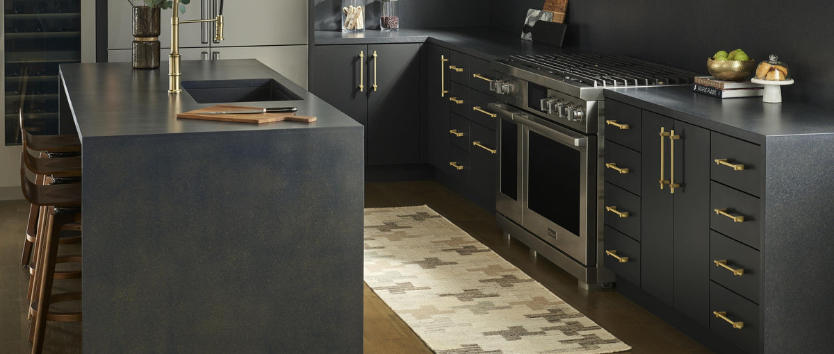 Dark kitchen cabinets with brass bar pulls